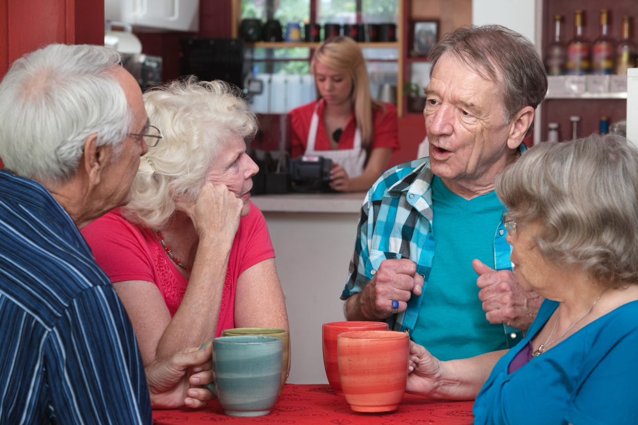 Four people chatting in a cafe