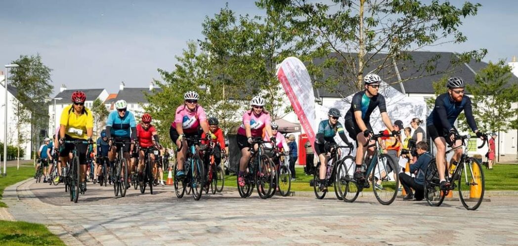 Group of cyclists in cycling gear get ready to start the Chapelton race