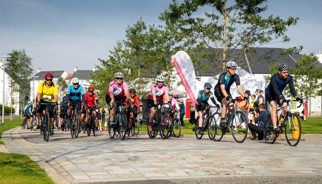 Group of cyclists in cycling gear get ready to start the Chapelton race