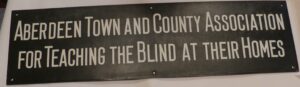 Image of original plaque of Aberdeen Town and County Association for Teaching the Blind at their Homes 