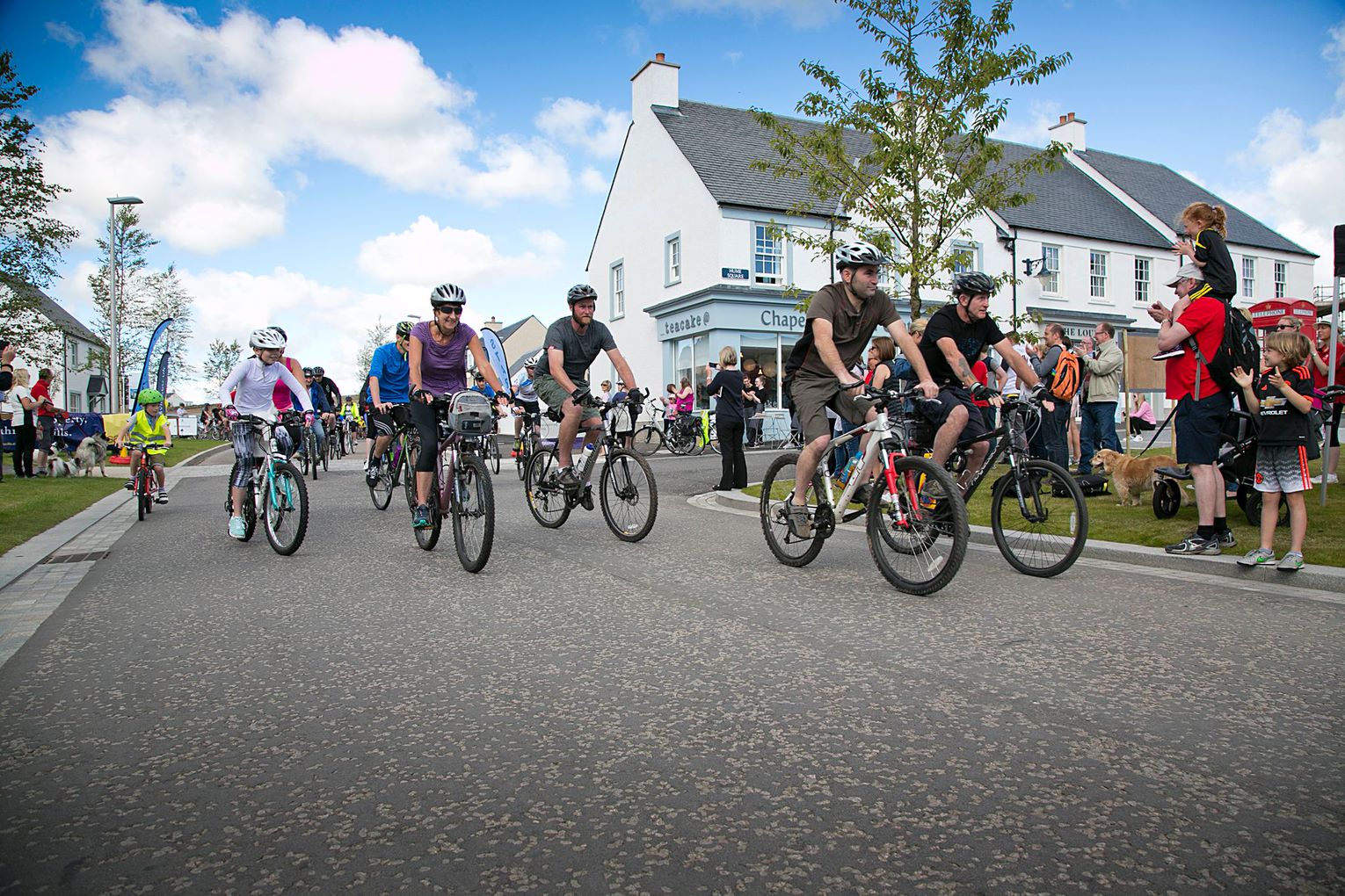 Image depicts cyclists setting off at the beginning of a race