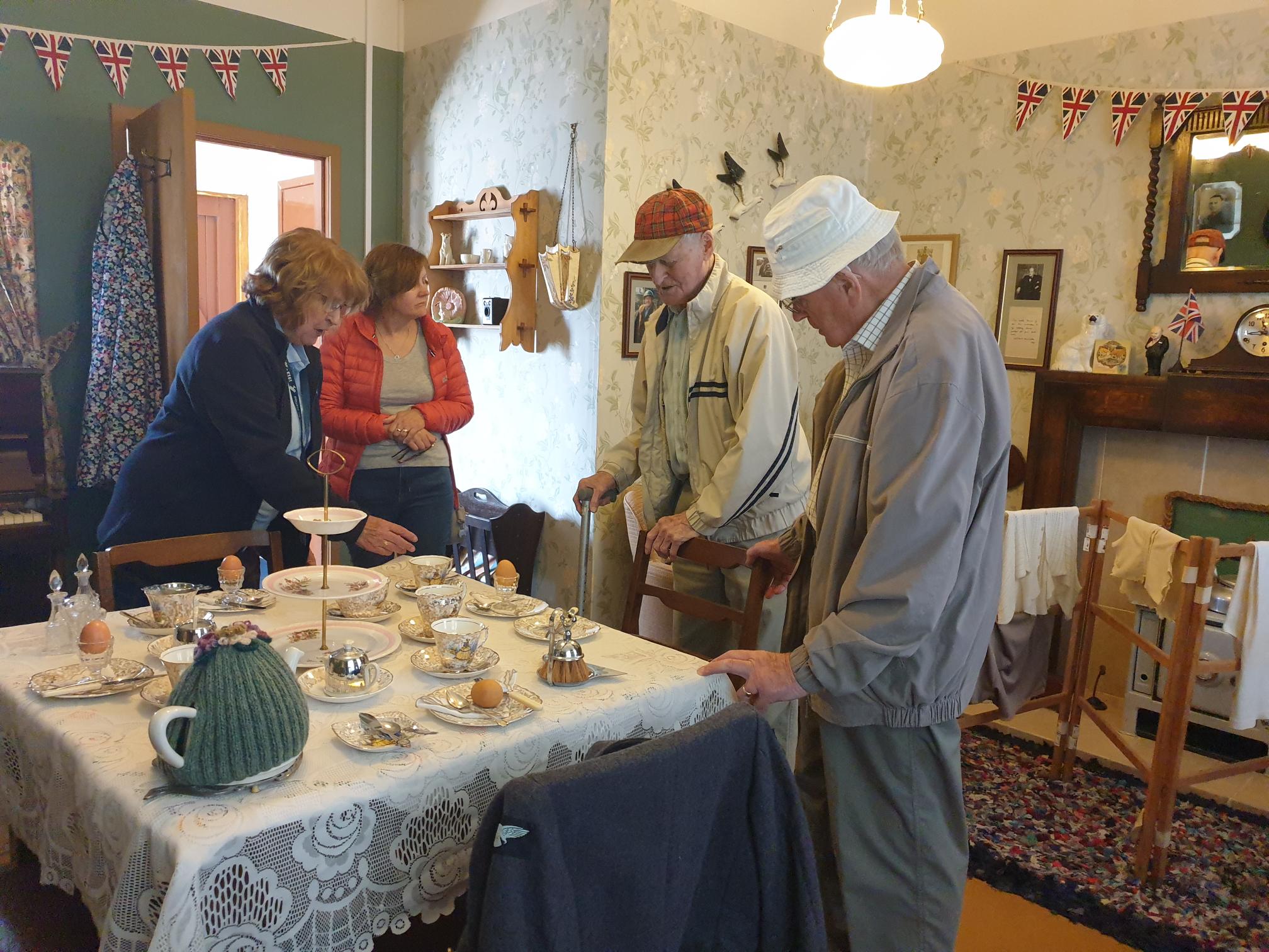 Group members visit a historic tea table set up