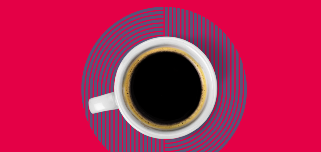 Birds eye view of coffee against blue patterned coaster with a red background