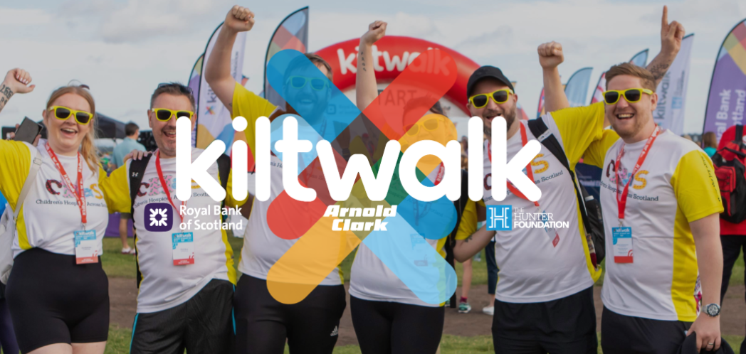 image of people holding their hands up ready to start the Kiltwalk