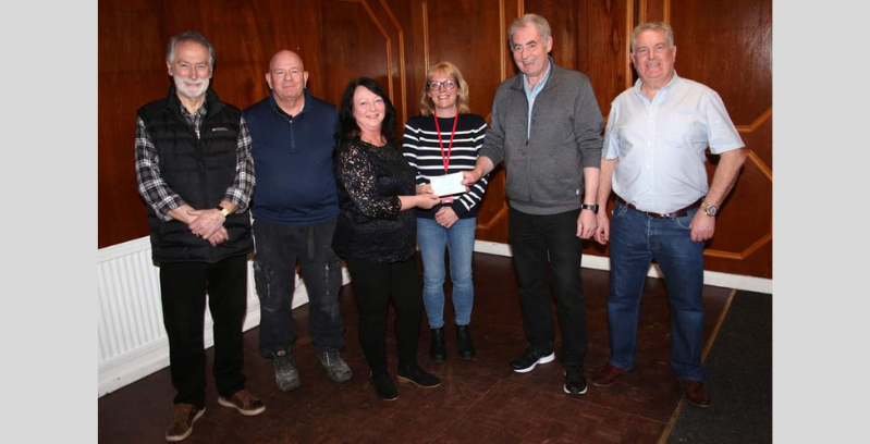Members of Arbroath Masonic lodge stand with Lorraine Middleton and Laura Ramsay from NESS holding a cheque